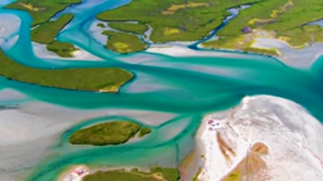 Turbulent Water Flow Along Sandy Coast and Green Islands
