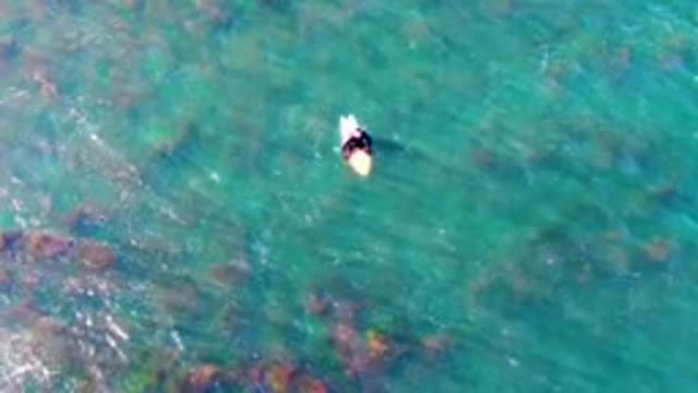LA BOCANA BCS MEXICO-2022: Person Floating on a Board in Turquoise Ocean Water