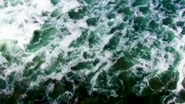 LA BOCANA BCS MEXICO-2022: Ocean Waves with White Foam Moving Across Water Surface