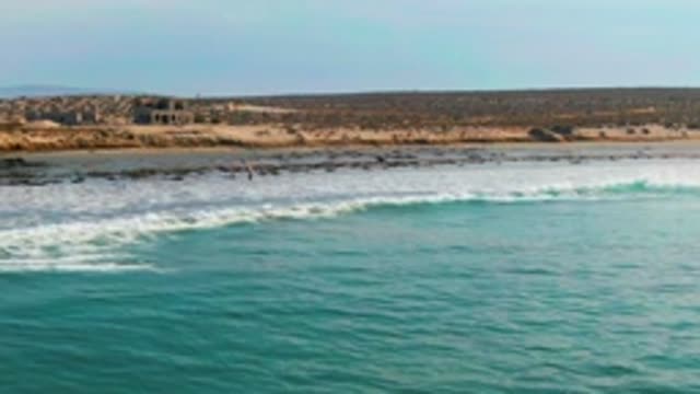 LA BOCANA BCS MEXICO-2022: Ocean Waves Breaking on Sandy Beach with Surfers