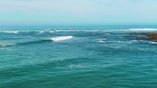 LA BOCANA BCS MEXICO-2022: Ocean Waves Breaking with Swimmer in Turquoise Water