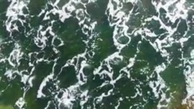 LA BOCANA BCS MEXICO-2022: Ocean Waves Receding with White Foam on Green Water