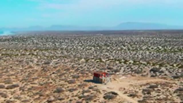 LA BOCANA BCS MEXICO-2022: Desert Landscape with Red Structure and Dissipating Smoke Plume