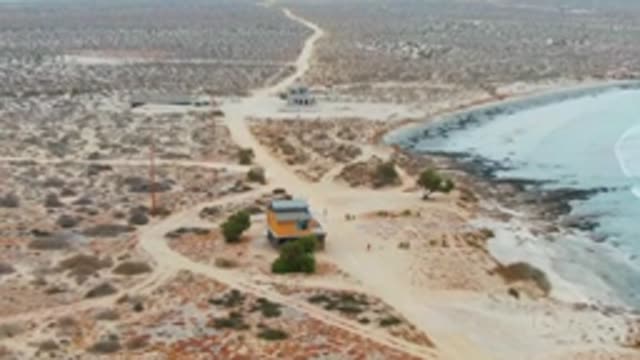 LA BOCANA BCS MEXICO-2022: Coastal Desert Scene with Small Structure and Sandy Paths