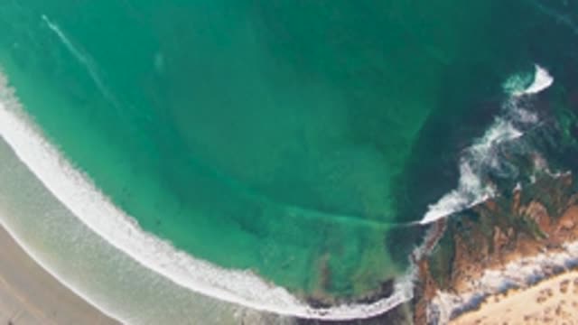LA BOCANA BCS MEXICO-2022: Gentle Ocean Waves Rolling Onto Sandy Shore