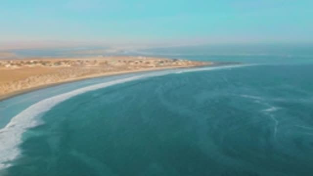 LA BOCANA BCS MEXICO-2022: Gentle Ocean Waves Rolling Onto Sandy Shore