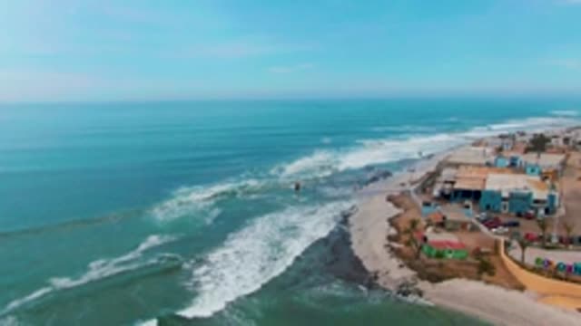 PUENTA ABREOJOS BCS MEXICO-2022: Waves Crashing on Coastal Shore with Buildings