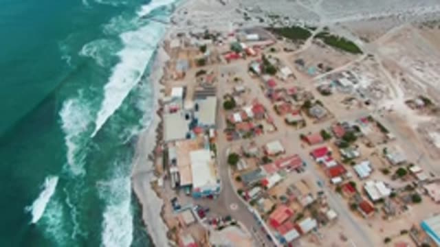 PUENTA ABREOJOS BCS MEXICO-2022: Coastal Settlement with Moving Ocean Waves and Sandy Shore