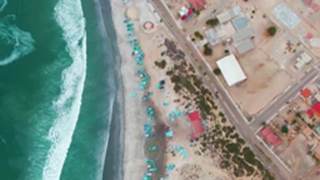 PUENTA ABREOJOS BCS MEXICO-2022: Coastal Shoreline with Rolling Waves and Beach Umbrellas