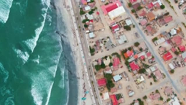 PUENTA ABREOJOS BCS MEXICO-2022: Coastal Residential Area with Ocean Waves and Road Traffic