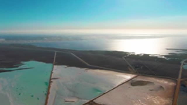 GUERRERO NEGRO BCS MEXICO-2022: Salt Evaporation Ponds with Vehicle Moving on Adjacent Road