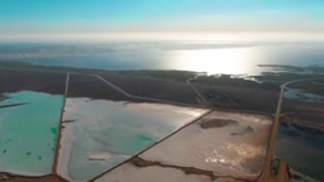 GUERRERO NEGRO BCS MEXICO-2022: Aerial Pan of Colorful Salt Evaporation Ponds and Ocean
