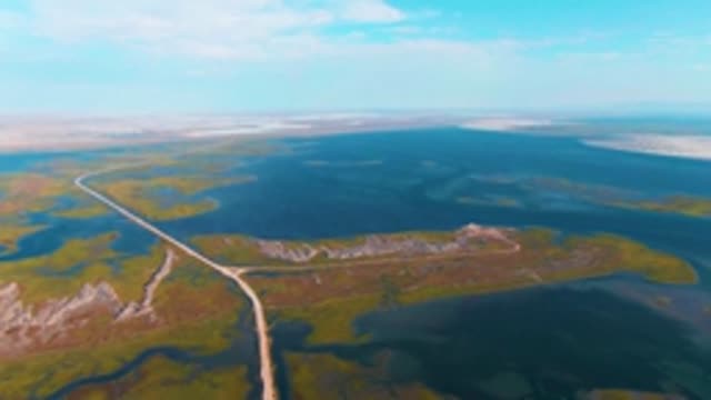 GUERRERO NEGRO BCS MEXICO-2022: Winding Dirt Road Through Wetland Lakes and Grasslands