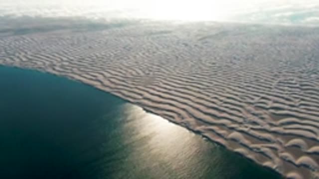 GUERRERO NEGRO BCS MEXICO-2022: Wavy Sand Dunes Along Ocean Shore at Sunrise