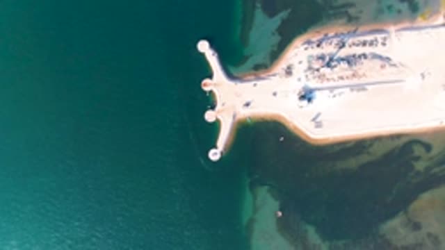 GUERRERO NEGRO BCS MEXICO-2022: Pier with Circular Markers Extending Into Teal Water