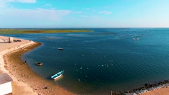 GUERRERO NEGRO BCS MEXICO-2022: Coastal Shore with Small Boat and Moving Water