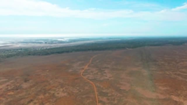GUERRERO NEGRO BCS MEXICO-2022: Winding Dirt Road in Arid Landscape