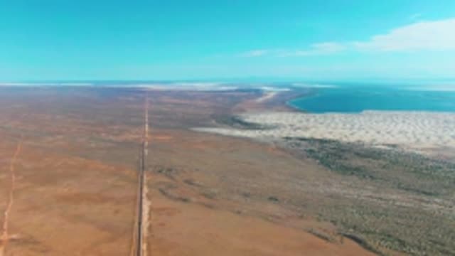 GUERRERO NEGRO BCS MEXICO-2022: Desert Road and Salt Lake Under Clear Sky