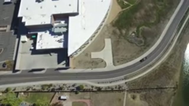 HIDDEN LAKE COLORADO-2016: An Aerial View Of A Black And Windy Road And Green