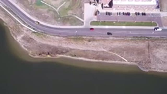 HIDDEN LAKE COLORADO-2016: Cars Driving Along Road In The City With Plane View