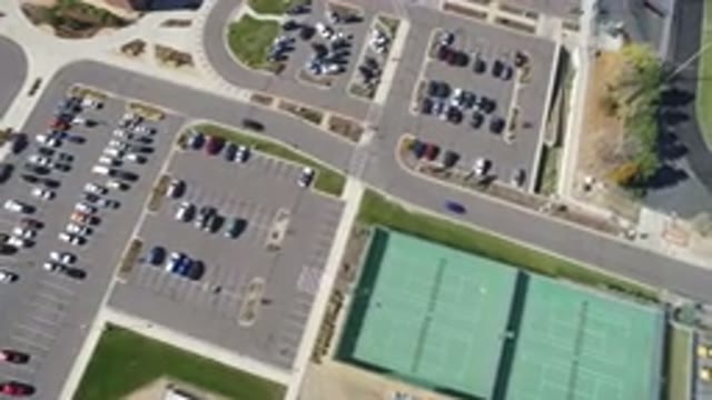 HIDDEN LAKE COLORADO-2016: A Blue And A Black Car Leaving A Parking Area