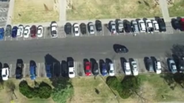 HIDDEN LAKE COLORADO-2016: Car Ring Through A Parking Lot Looking For A Space To Park