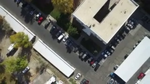 HIDDEN LAKE COLORADO-2016: A Drone Flying Over Parking Lot Near A Building In