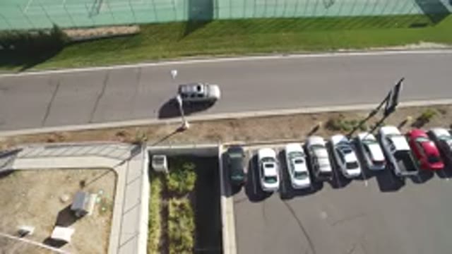 HIDDEN LAKE COLORADO-2016: A Car Driving Across The Street Near Other Packed Cars