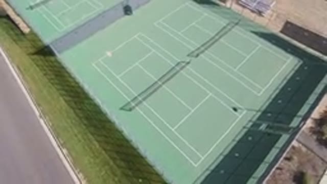 HIDDEN LAKE COLORADO-2016: An Aerial View Of A Green Empty Tennis Court That Is
