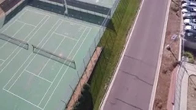 HIDDEN LAKE COLORADO-2016: An Aerial View Of A Green Empty Tennis Court That Is