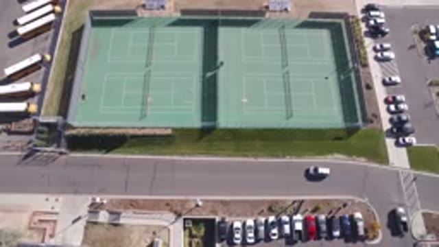 HIDDEN LAKE COLORADO-2016: Drone Shot Of Tennis Courts And Cars Leaving A Nearby Parking Lot