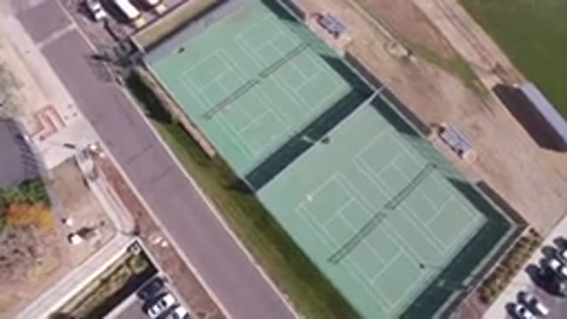 HIDDEN LAKE COLORADO-2016: Flying Freely Over Tennis Court With Its Parking Lot
