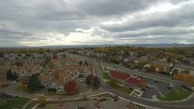 HIDDEN LAKE COLORADO-2016: Drone View Of A Cloudy City With Houses And Cars On