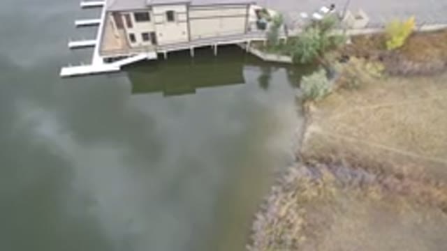 HIDDEN LAKE COLORADO-2016: Drone Rising Over Body Of Water With Empty Docks