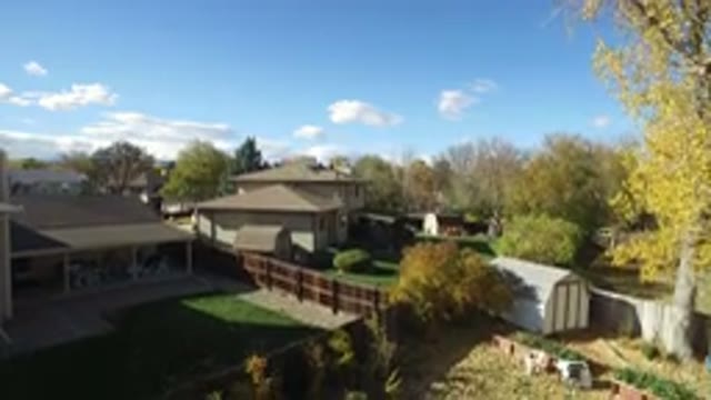 HIDDEN LAKE COLORADO-2016: A Man Walking In His Garden And Drone Just About To