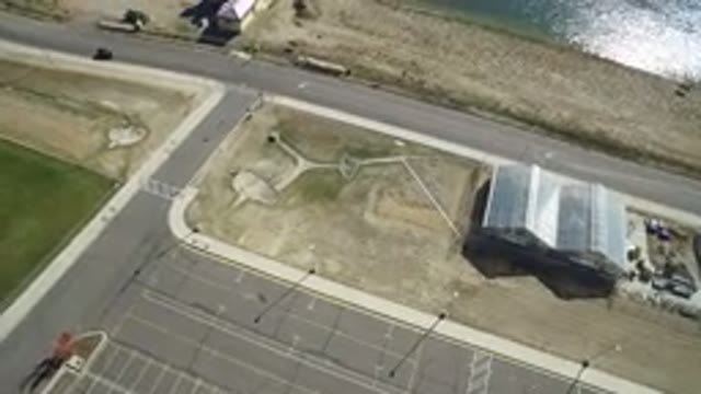 HIDDEN LAKE COLORADO-2016: Aerial View Of Car Driving Down Road Past House And