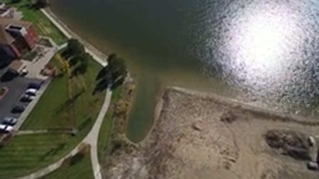 HIDDEN LAKE COLORADO-2016: Plane Flying Over A City And Nature Trees And