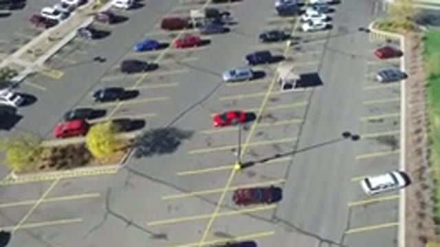 HIDDEN LAKE COLORADO-2016: Flying From Left To Right Over A Parking Lot With