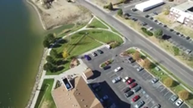 HIDDEN LAKE COLORADO-2016: Drone Filming A Road Near A Lake And Factories With