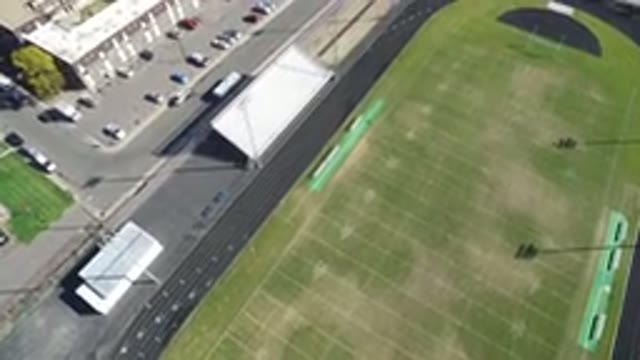 HIDDEN LAKE COLORADO-2016: Top View Of A Green And Empty Football Field And Cars