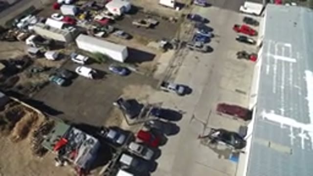 HIDDEN LAKE COLORADO-2016: Drone Over Dirt Pavement Industrial Lot Cars Parked