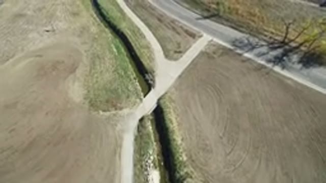 HIDDEN LAKE COLORADO-2016: Slow Overhead View Of Curved Road With Dirt Paths