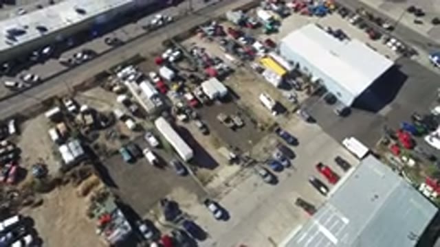 HIDDEN LAKE COLORADO-2016: Two Blue and Red Buildings with White Cars in Parking Lot