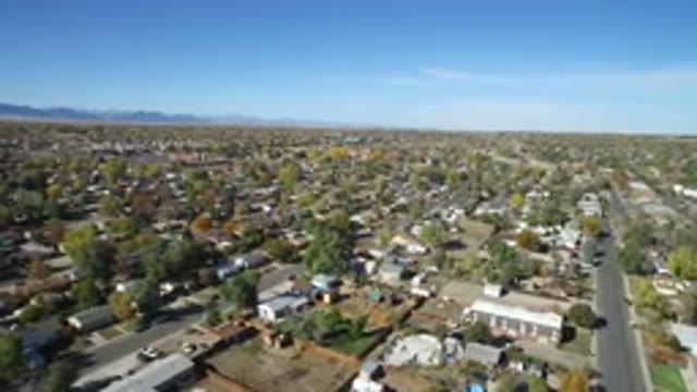 HIDDEN LAKE COLORADO-2016: Very High Drone Image Of A City With Many Streets And Trees