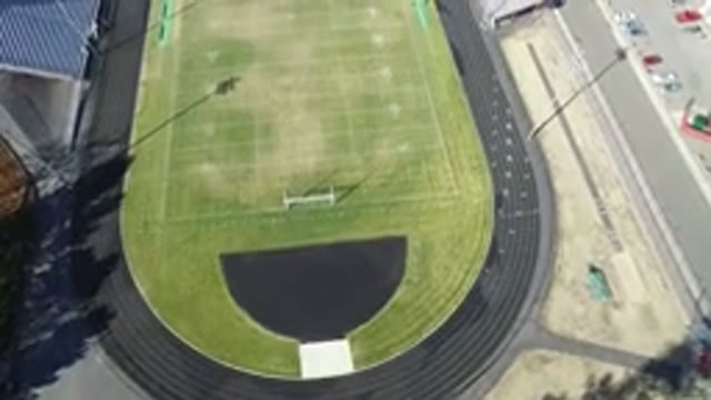 HIDDEN LAKE COLORADO-2016: Green Football Pitch With Stands And Parking Area On