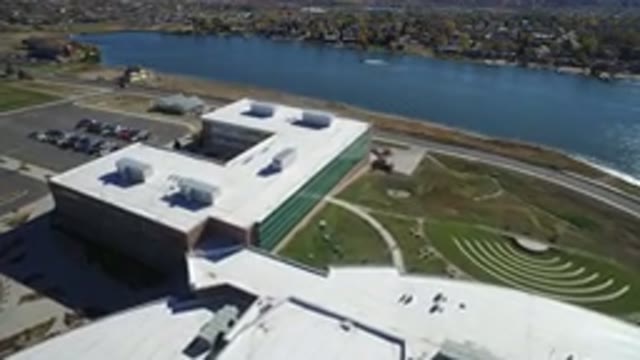 HIDDEN LAKE COLORADO-2016: A Large Building With A Parking Lot Sits Next To A River