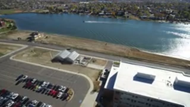 HIDDEN LAKE COLORADO-2016: Aerial View Of Building Parking Lot Car Driving Down