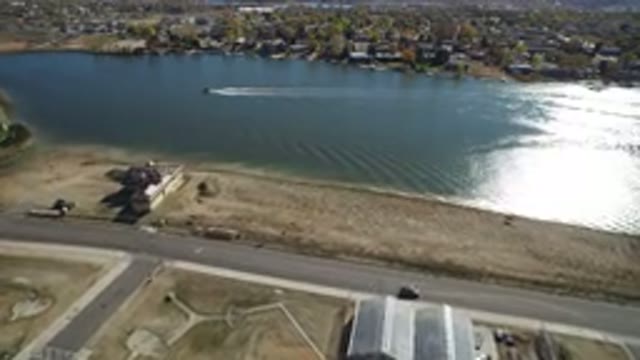 HIDDEN LAKE COLORADO-2016: Boat Sailing In A Lake Near A Town And On The Bank Of