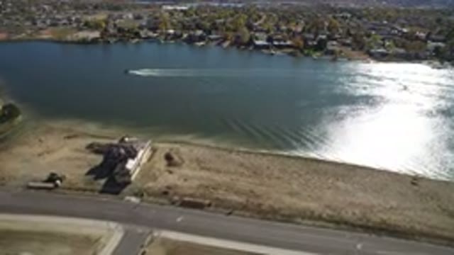 HIDDEN LAKE COLORADO-2016: Plane Flying Across Water With House And Land