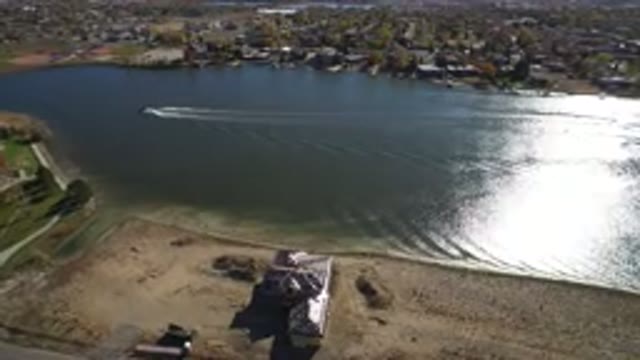 HIDDEN LAKE COLORADO-2016: A Boat Is Moving Through A Calm And Clean Lake